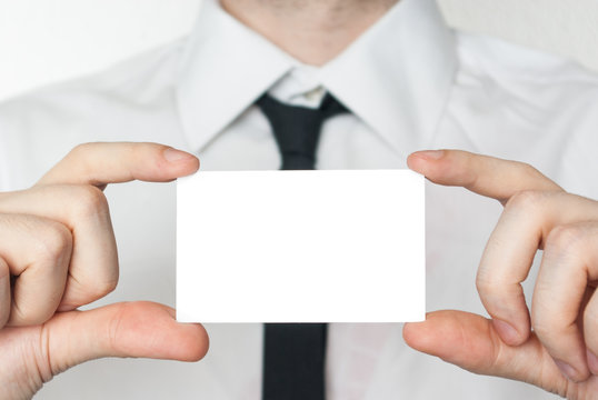 Man in tie showing and holding a card