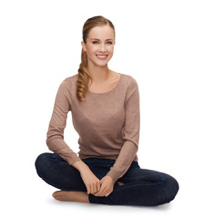 smiling young woman sitting on floor