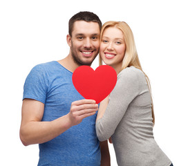 smiling couple holding big red heart