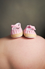Pregnant bump and babies first shoes