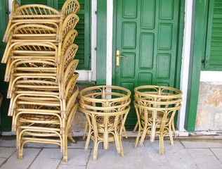 Stored chairs and tables at a terrace in the city