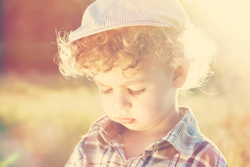 Child boy in  hat in summer outdoors