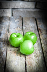 Fresh farm raised apples on rustic wooden background