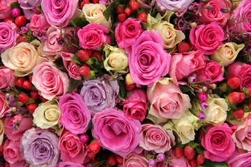 Pink and purple roses in a wedding centerpiece