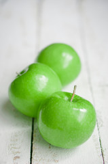 Fresh farm raised apples on rustic wooden background