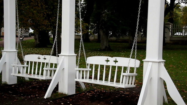 Two white bench swing