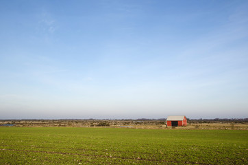 Small red barn at a great plain area