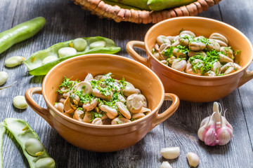 Closeup of broad beans with parsley and garlic