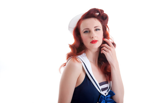 Beautiful retro pin-up girl in a sailor style dress