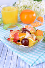 Sweet fresh fruits in bowl on table close-up