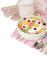 Delicious oatmeal with fruit in bowl on table close-up