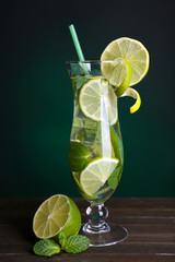 Glass of cocktail with lime and mint