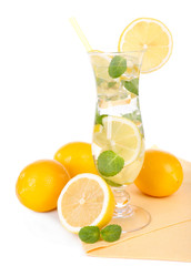 Glass of cocktail with lemon and mint isolated on white