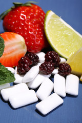 Chewing gums with fruit taste,   on color wooden background