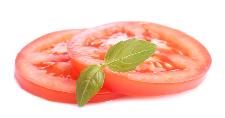 Slices of fresh tomato with basil, isolated on white