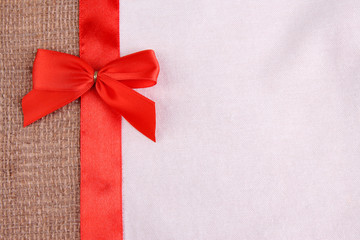 Color ribbon and bow on two color fabrics background