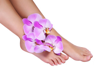 Pedicure with pink orchid flowers isolated