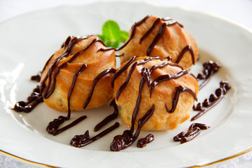 profiteroles with cream and chocolate sauce.