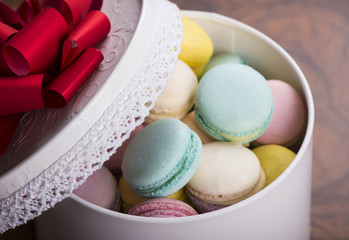 Pastel color macaroons in vintage round box closeup