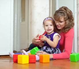  mother and baby plays with blocks