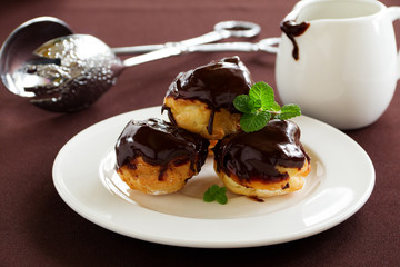 profiteroles with cream and chocolate sauce.