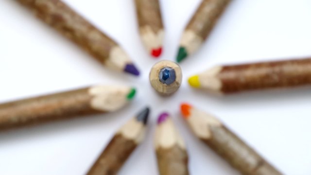 Wooden pencil from branchesare spinning on a white background