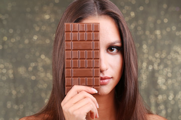 Portrait of beautiful young girl with chocolate