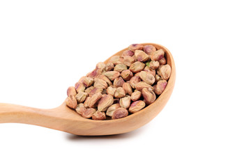 Wooden spoon with pistachios.