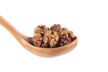 Wooden spoon full with walnuts.