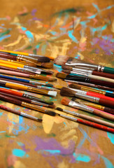 Brushes on multicolor  wooden background