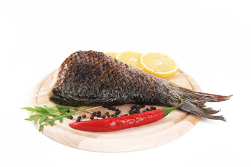 Fried carp on wooden platter.