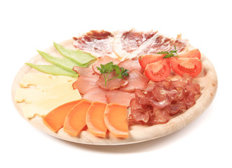 Types of cheese and meat on wood platter.