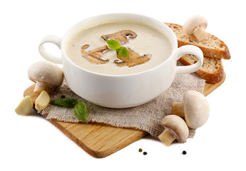 Mushroom soup in white bowl, on napkin, isolated on white