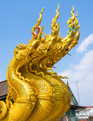 Golden king of Naga with sky at public temple