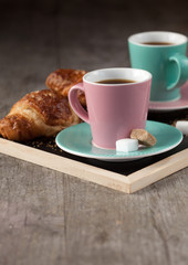 Coffee cups and croissants