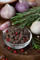 dried peppers, garlic and fresh rosemary on a wooden board