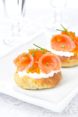potato bun with salted salmon, red caviar and chives, vertical