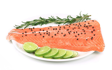 Salmon fillet with pepper on plate.