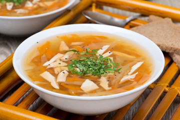 vegetable soup with chicken and greens, close-up