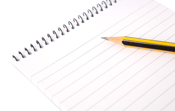 Notepad and pencil over white background