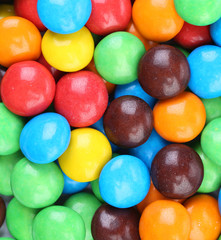 Backgroynd of chocolate balls in colorful glaze.