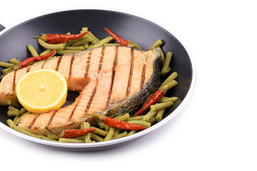 Frying pan with salmon steak.