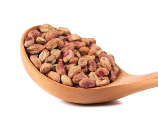Wooden spoon with pistachios.