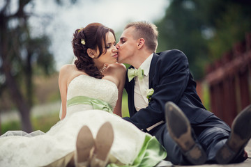 wedding. Beautiful newly married couple kissing on a bridge