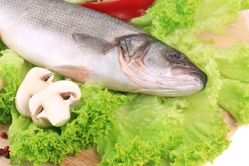 Fresh seabass on platter with lettuce.