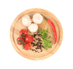 Vegetables on wooden platter.