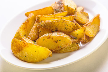 Naklejka na ściany i meble roasted potato wedges on a white plate