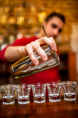 Close-up of Barman pouring alcoholic drink and cocktails
