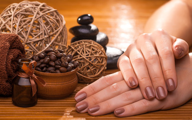 beautiful brown manicure on a bamboo background