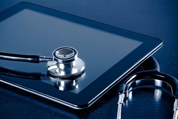 medical stethoscope on modern digital tablet pc in laboratory